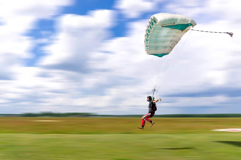 Skydiver landing on a high perofrmance canopy in a high speed swooping competition.