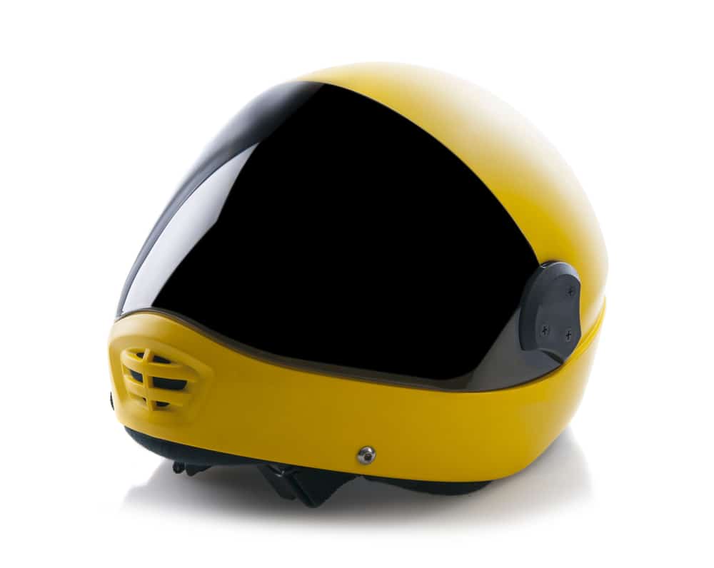 Yellow toned helmet for parachuting / skydiving on white background.