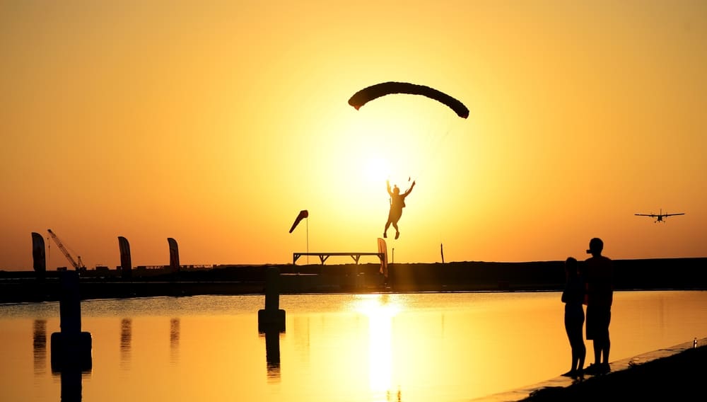 Man flyving over lake during swooping competition in Dubai.